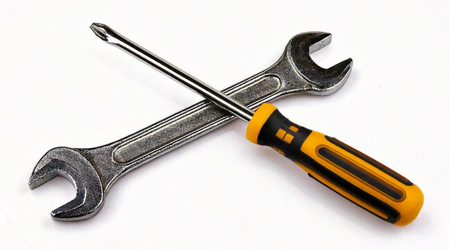 A wrench and a screwdriver crossed together, isolated on a white surface