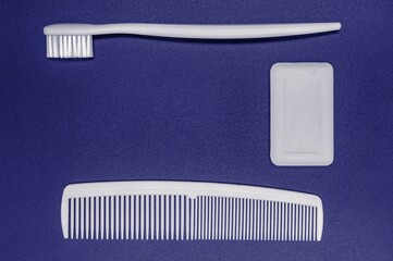 toothbrush, soap, comb on a blue background