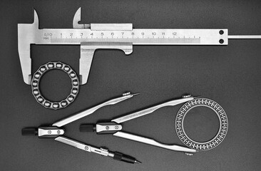 caliper, two compasses and bearings on a black background