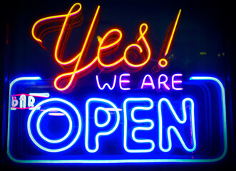 Yes, we're open - glowing neon sign board on glass window during night time