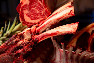 Raw fresh meat beef ribeye steak on a wooden table in a butcher shop. Juicy fresh meat steak on...