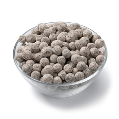 Glass bowl with uncooked black tapioca pearls close up isolated on white background