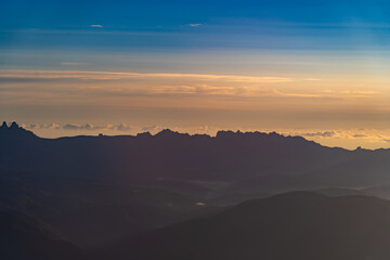 Stunning sunset over mountain peaks creates a breathtaking landscape filled with vibrant colors and tranquility during evening hours