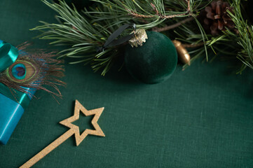 Christmas decorations festive frame on the green linen cloth. Close up. Copy space