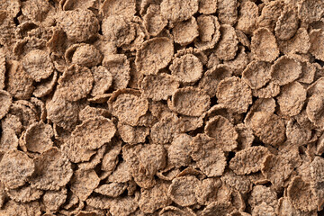 Dried buckwheat flakes full frame close up as background