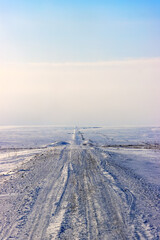 Ice road trucker in a remote area for trucks. A road built in the tundra for the needs of the Russian oil and gas industry.