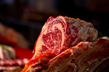 Close up meat beef ribeye steak on a wooden table in a butcher shop. Juicy fresh meat steak on...