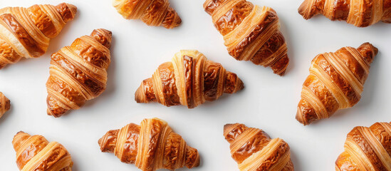 Golden croissants on white background 