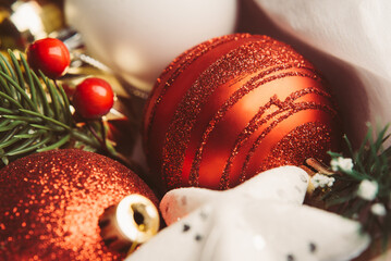 Close-up of Christmas tree decorations. Red balloons and baubles. Holiday and New Year concept. Idea for a card or poster.