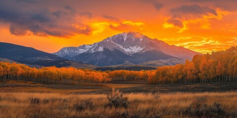Fototapeta premium A breathtaking sunset view over mountains, showcasing vibrant autumn colors and dramatic lighting.