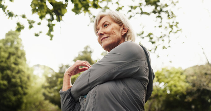 Outdoor, park and mature woman with stretching, smile and calm from exercise and fitness with bottle. Nature, thinking and wellness with idea, training and workout for health in the morning on break