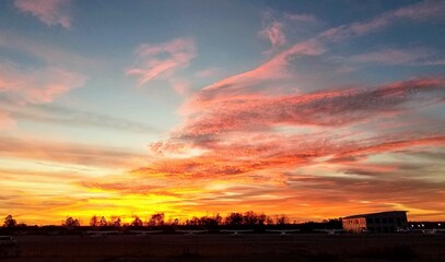 dramatic red, orange, yellow, and pink sunrise