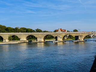 Fototapeta premium Beautiful aerial view of Regenesburg, its massive gothic St Peter cathedral, the Danube river and the Old Stone Bridge