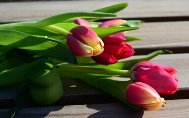 Vibrant tulip bouquet on wooden table.