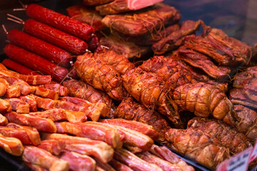 Wide range of smoked pork and lamb along with different types of salami in show window. Shop layout done in meat department. Food manufacture content.