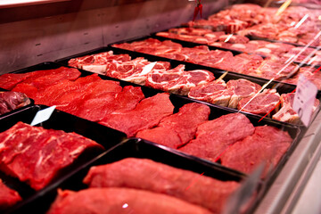 Raw beef meat freshly brought to market for sale. Selection of meat in a store. Food industry concept.
