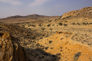 Trail going into the arid and rocky environment among the Granite hills of the Gondwana Sperrgebiet Rand Park, just next to the small town of Aus in Namibia