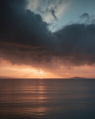 Obraz premium Stunning sunset over the sea rays of light through dark clouds and island view in the distance.