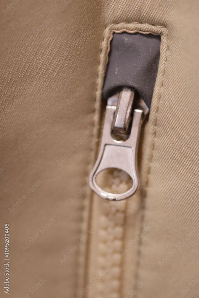 Poster a close-up view of a zipper on a bag, useful for e-commerce or travel images.