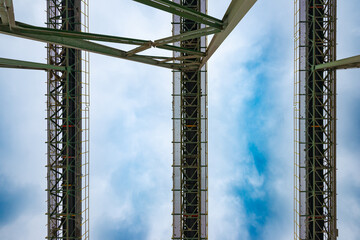 View from below of long conveyor belts and mineral processing plant at a copper mine in Chile.