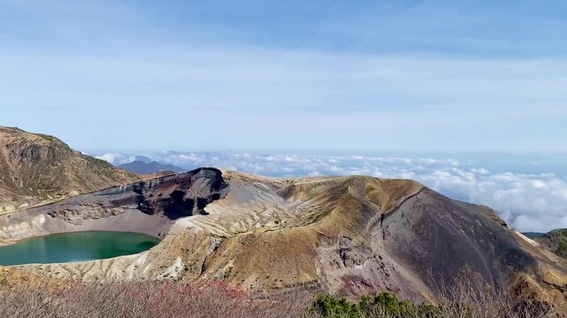 Okama Crater Lake on the sunny day. While local people call it affectionately Okama, the visitors tend to call it "Five Color Pond", because its color changes.