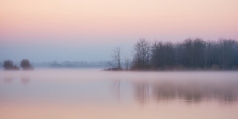 Fototapeta premium A tranquil sunrise over a misty lake showcasing the beauty of nature at dawn.