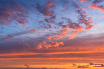 Glowing real sky at sunset texture background overlay. Dramatic red and orange clouds.