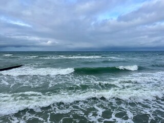 Cloudy seascape, seashore waves, natural sea horizon, cloudy sky