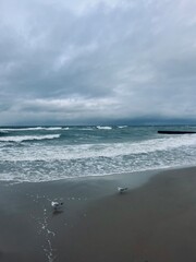 Cloudy seascape, seashore waves, natural sea horizon, cloudy sky