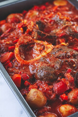 ossobuco stew with vegetables, knuckle on the bone with new potatoes, in tomato sauce,homemade, top view, no people,