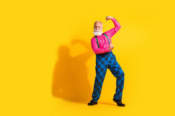 Full body photo of bearded gentleman flexing muscles wear fashionable clothes suspenders isolated...