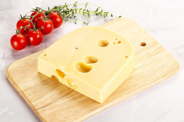 Maasdam cheese brick over board