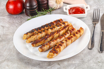 Grilled meat sausages wrapped bacon