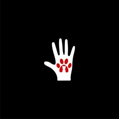 Human hand palm with dog or cat paw print symbol icon isolated on black background.