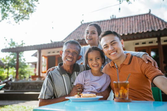 potrait of happy asian family having lunch together
