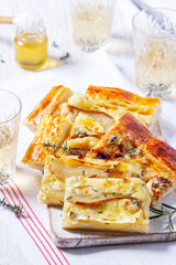 Puff pastry pie with cheese, pears, nuts and honey, served with champagne.