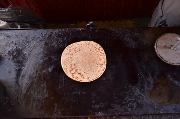 handmade whole wheat flour tortilla made on the comal