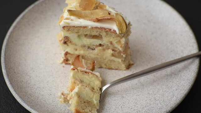 Layered sweet cake with cream, pear and dorblu cheese on a dark concrete background