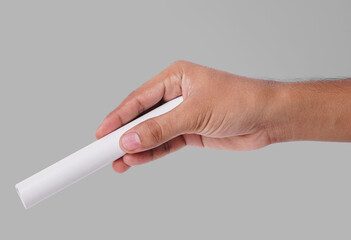 Closeup Photo Of A Male Hand Holding A New White PVC Plastic Pipe Isolated On Grey Background