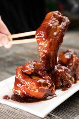 Pork ribs in honey soy sauce on a wooden background. Food concept. Chinese food.