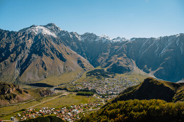 View on the small town of Stepantsminda and the Kazbegi valley from Gergeti Trinity Church in Georgia