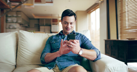 Sofa, man and smile with smartphone for chat, conversation and text message with contact at home. House, happy male person or relax with mobile app for dating website, online partner or profile match