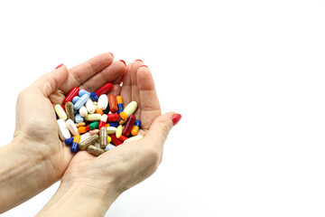 A woman's hand with a handful of pills or medicines