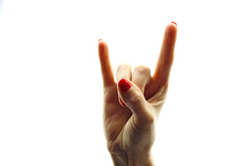 Woman's hand making horns symbol with fingers.