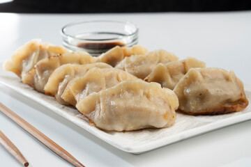 Dumplings with meat on a white background. Chinese dumplings are a traditional dish for Chinese New Year. Food concept. Chinese food.