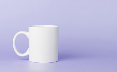 white cup for tea or coffee on a violet, purple background