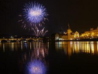 New Year's colorful fireworks with reflection on the river surface, festive mood