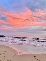 orange sunset on the beach is reflected in the water
