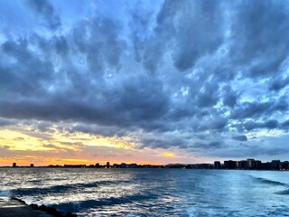 sunset over the sea with black clouds