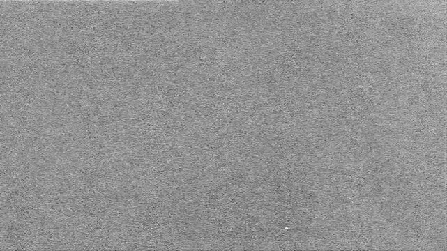 Gray static film grain texture with smooth surface and subtle cinematic noise loop overlay for retro-inspired editing and vintage aesthetic projects, 4K